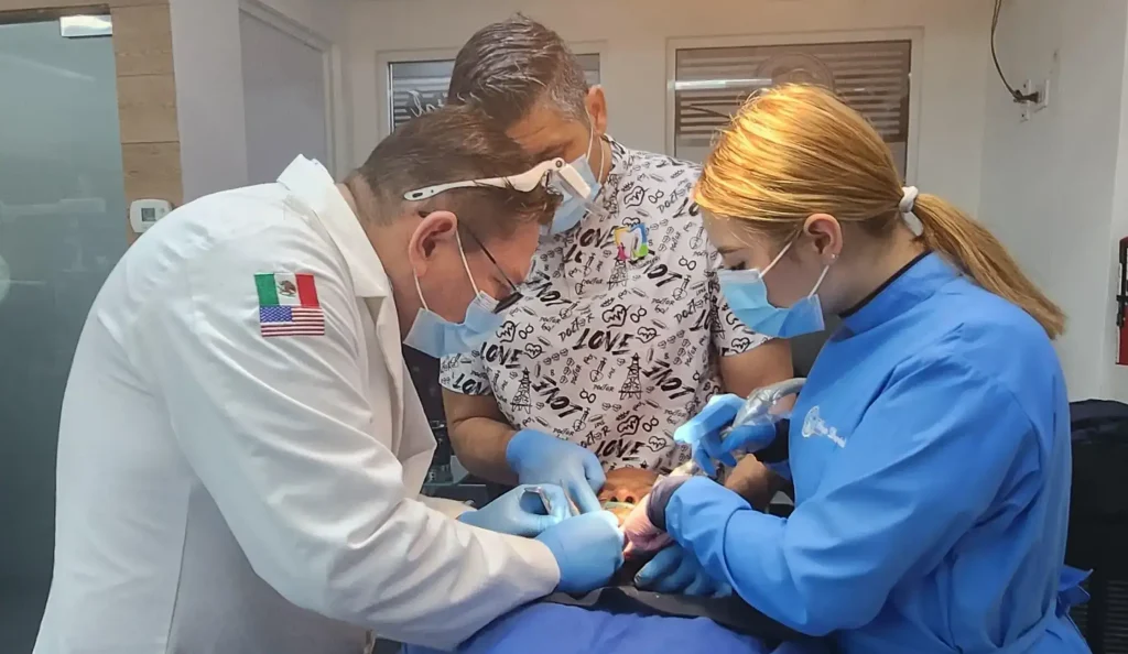 Dr. Alan Martinez performing dental implant surgery for a full-mouth restoration patient in Tijuana, Mexico