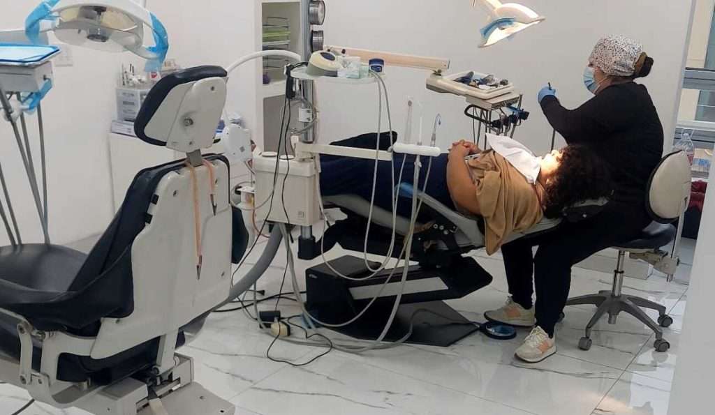 Dentist working in a modern treatment room at Dr. Mexico Dental Group in Tijuana, Mexico